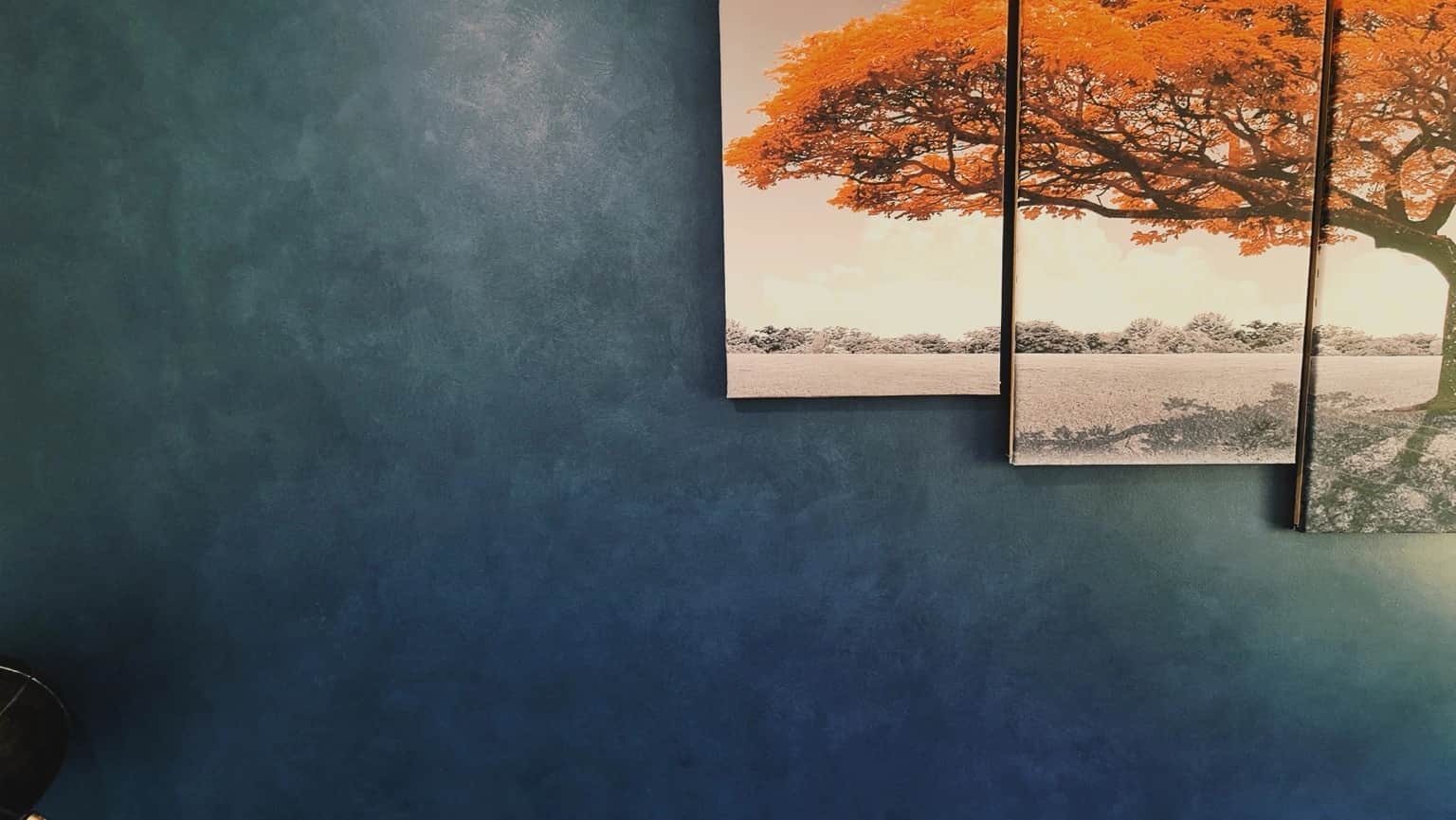 Close-up of blue Porter’s French Wash tonal variation beside multi-panel tree artwork in St Clair