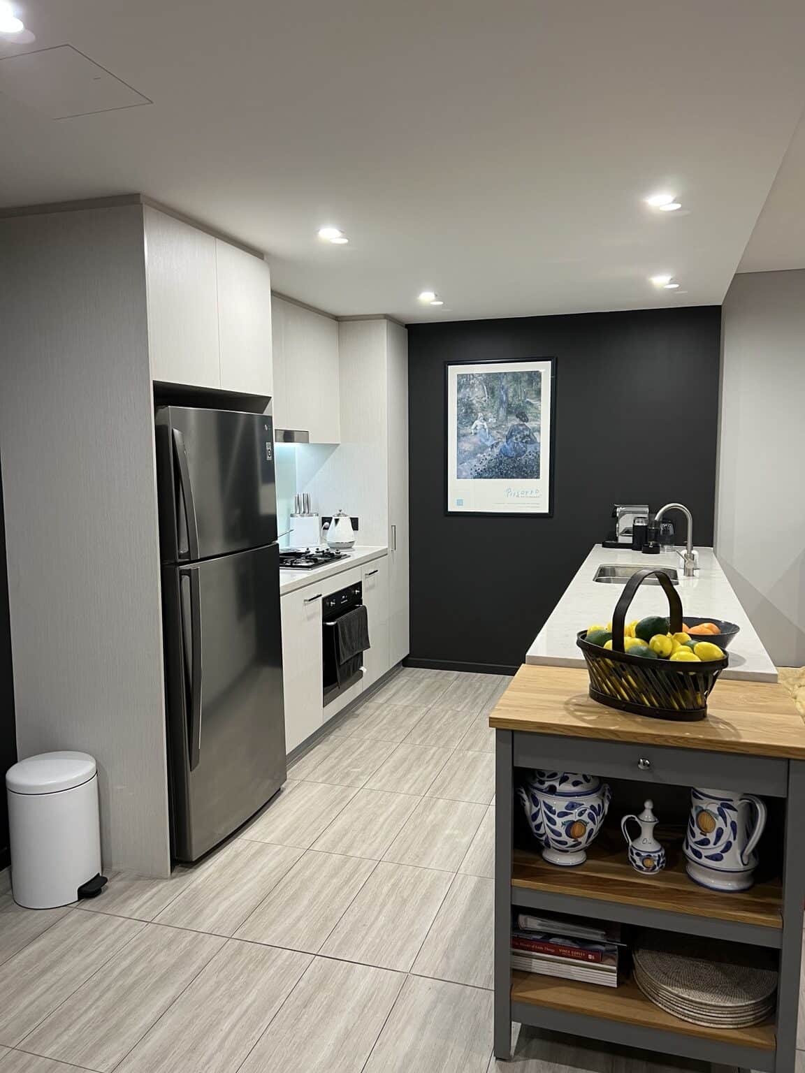 Completed kitchen feature wall painted with a modern dark finish in Rouse Hill