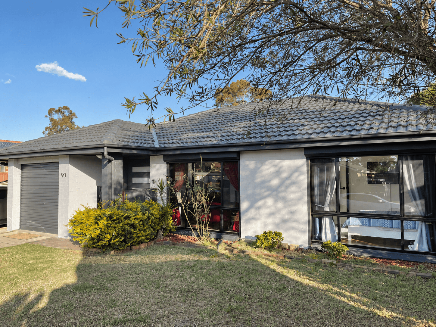 Completed pale grey painted brick exterior and charcoal trim on a St Clair home