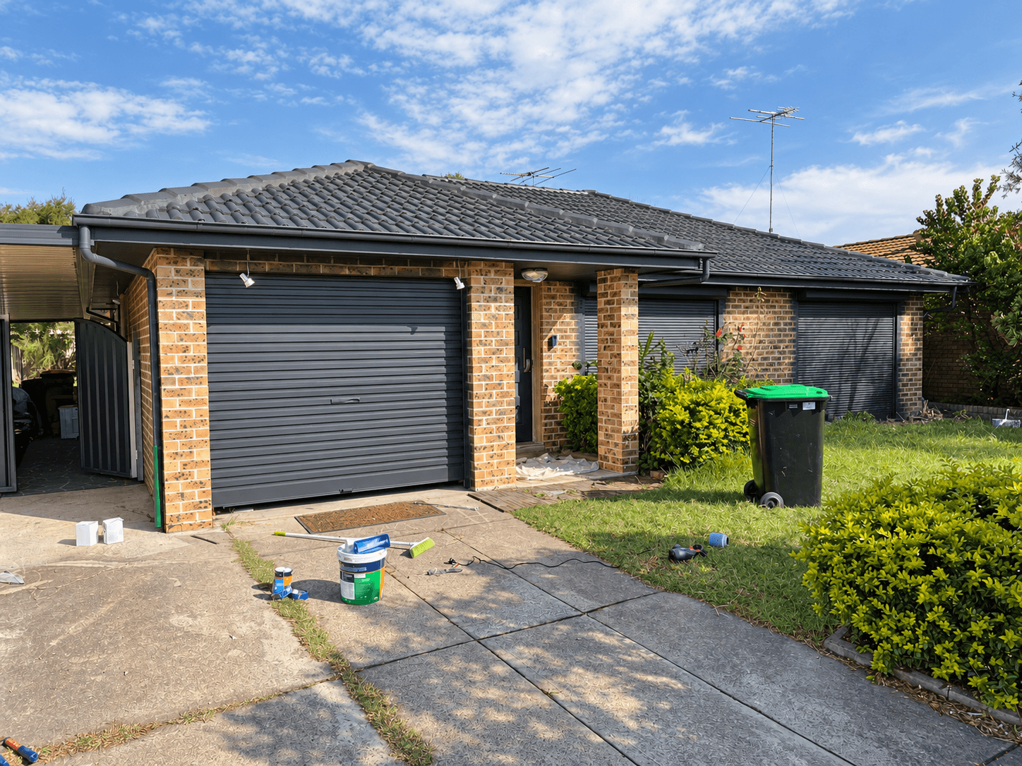 St Clair exterior painting in progress, showing the coated roof and garage before brick painting was complete