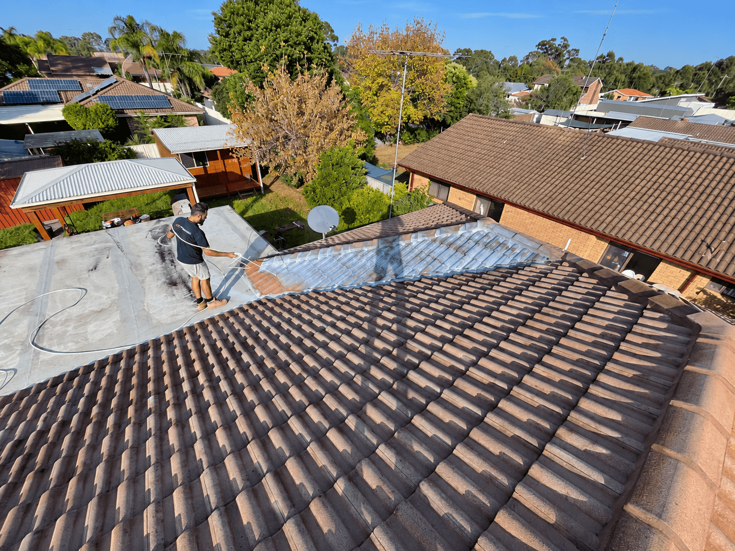 Roof primer being spray applied to tiled roofing in St Clair