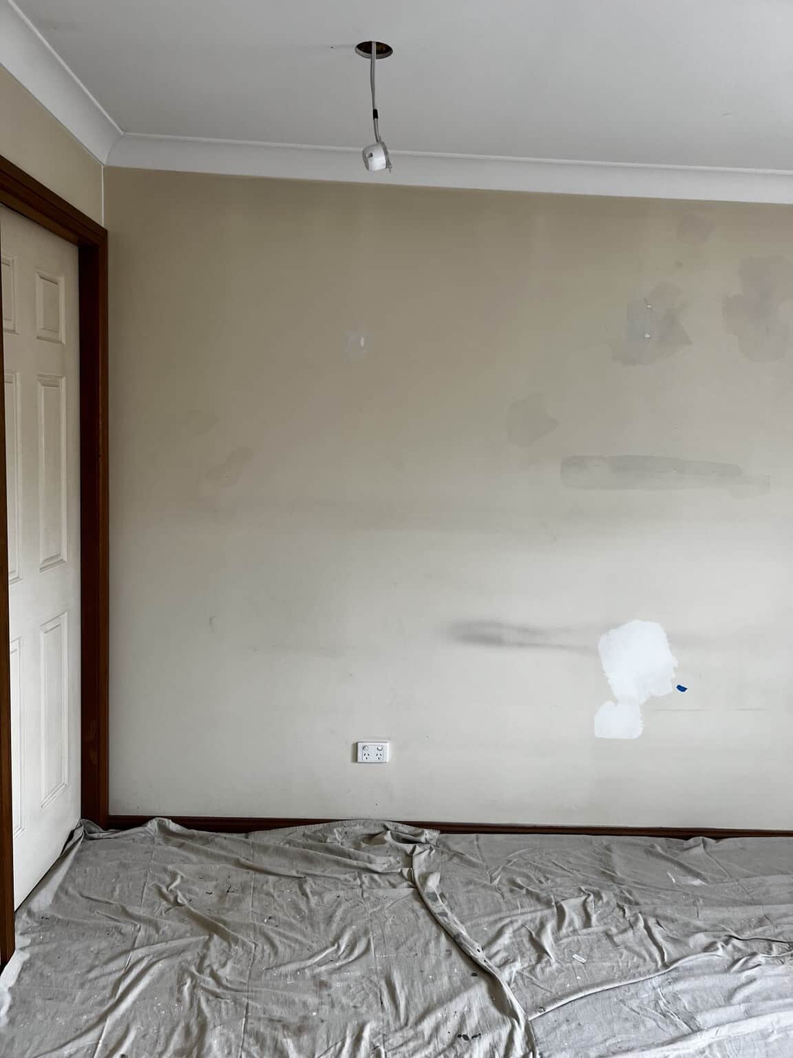 Bedroom wall showing filler patches and surface marks before repainting in St Marys.
