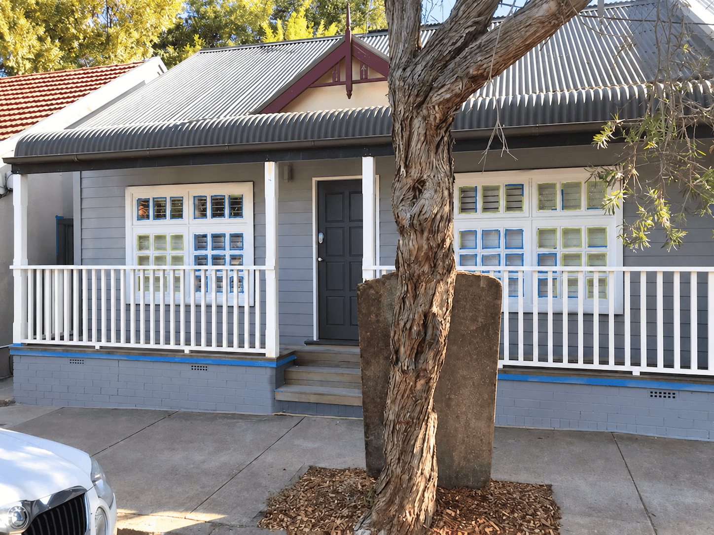 Stanmore front exterior during painting with windows masked