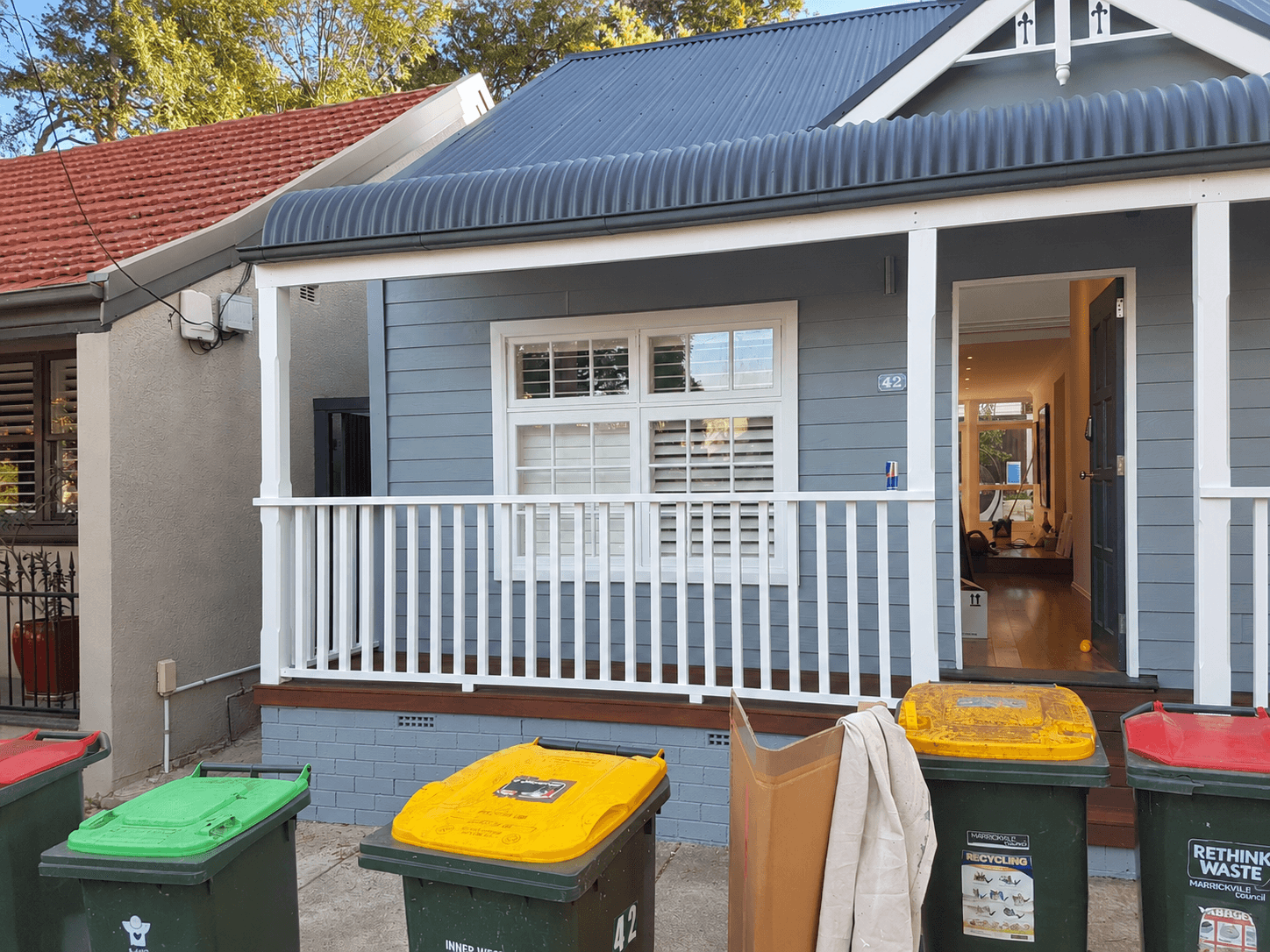 Finished grey weatherboard facade and white verandah balustrade in Stanmore