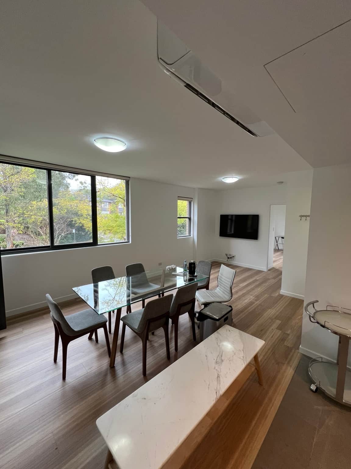 Wahroonga apartment dining area after painting, with white walls and ceiling above timber flooring