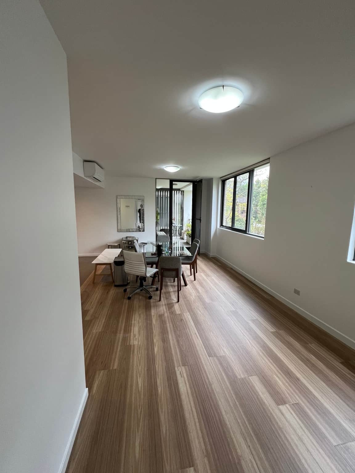 Completed white living and dining room in Wahroonga, viewed towards the balcony