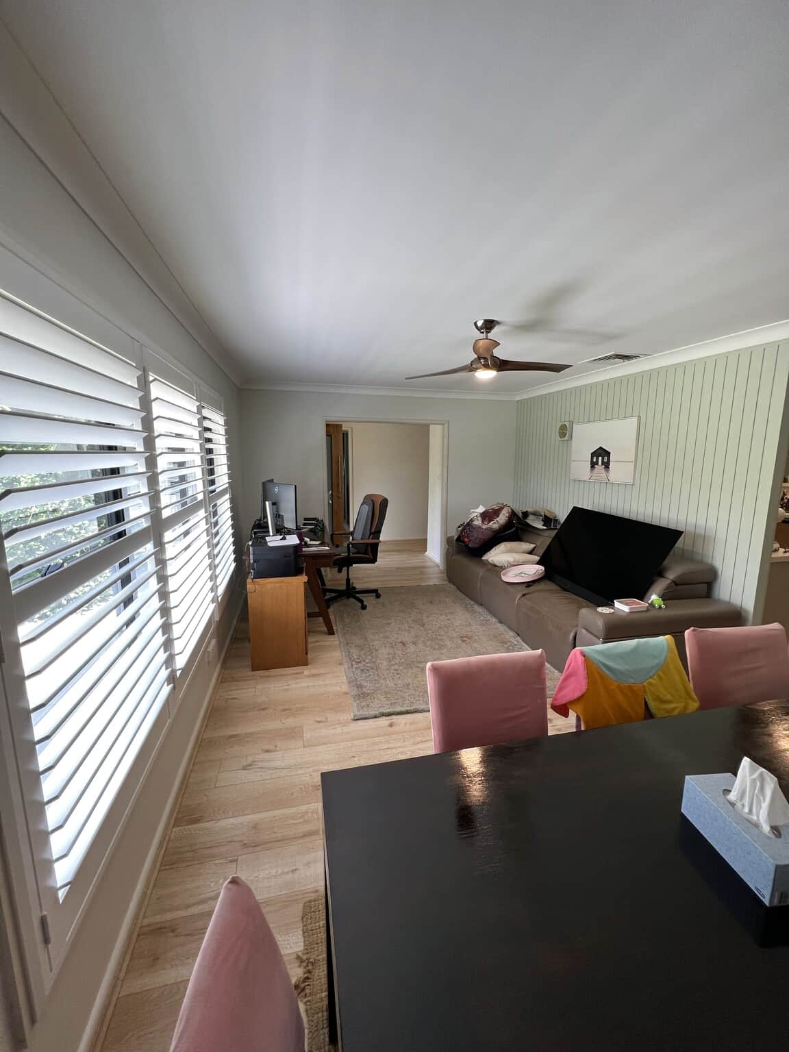 Completed Winston Hills living room repaint with smooth walls, a fresh white ceiling and light green feature wall.