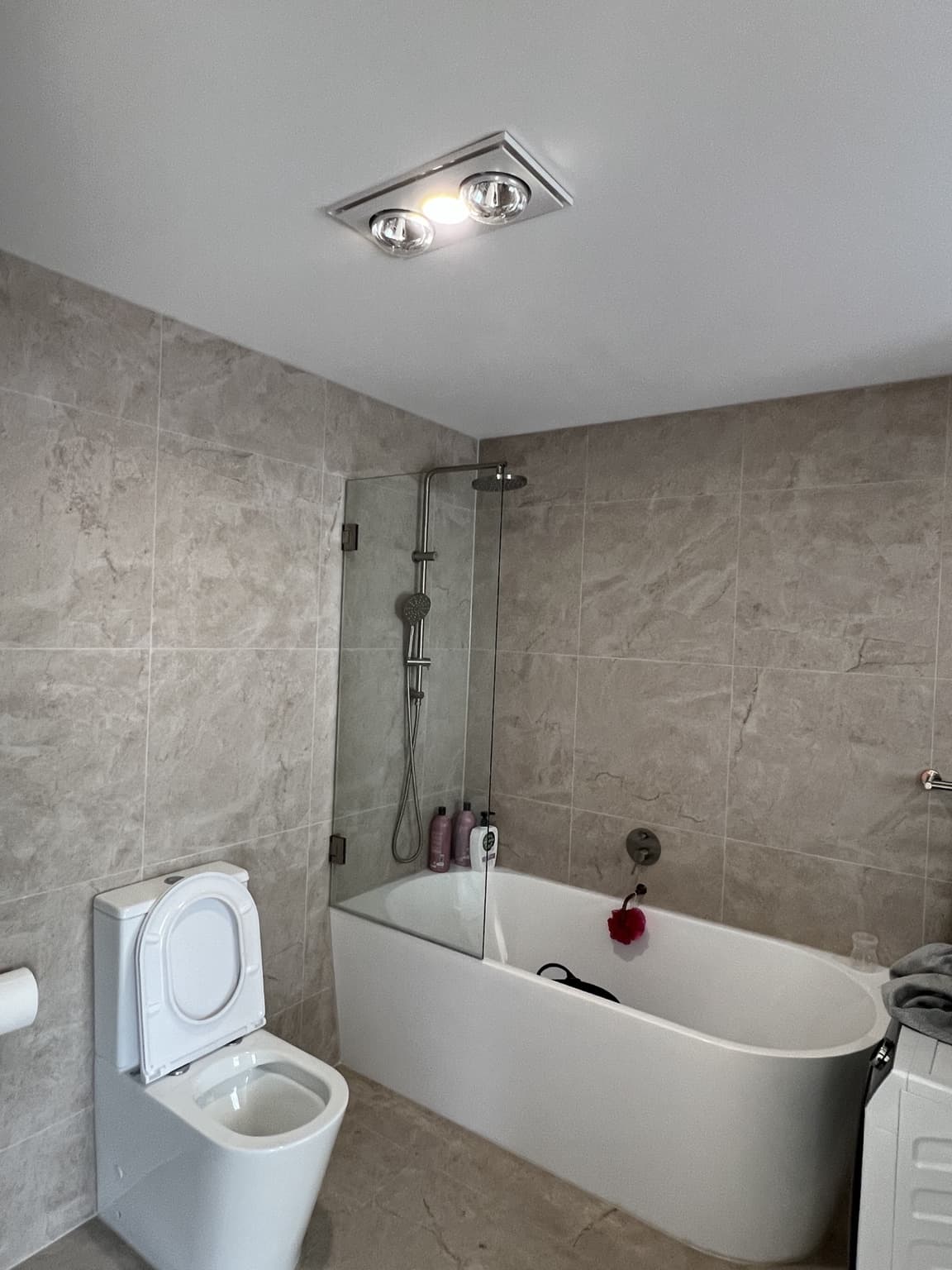 Finished painted bathroom ceiling above the bath and shower in Bexley, after