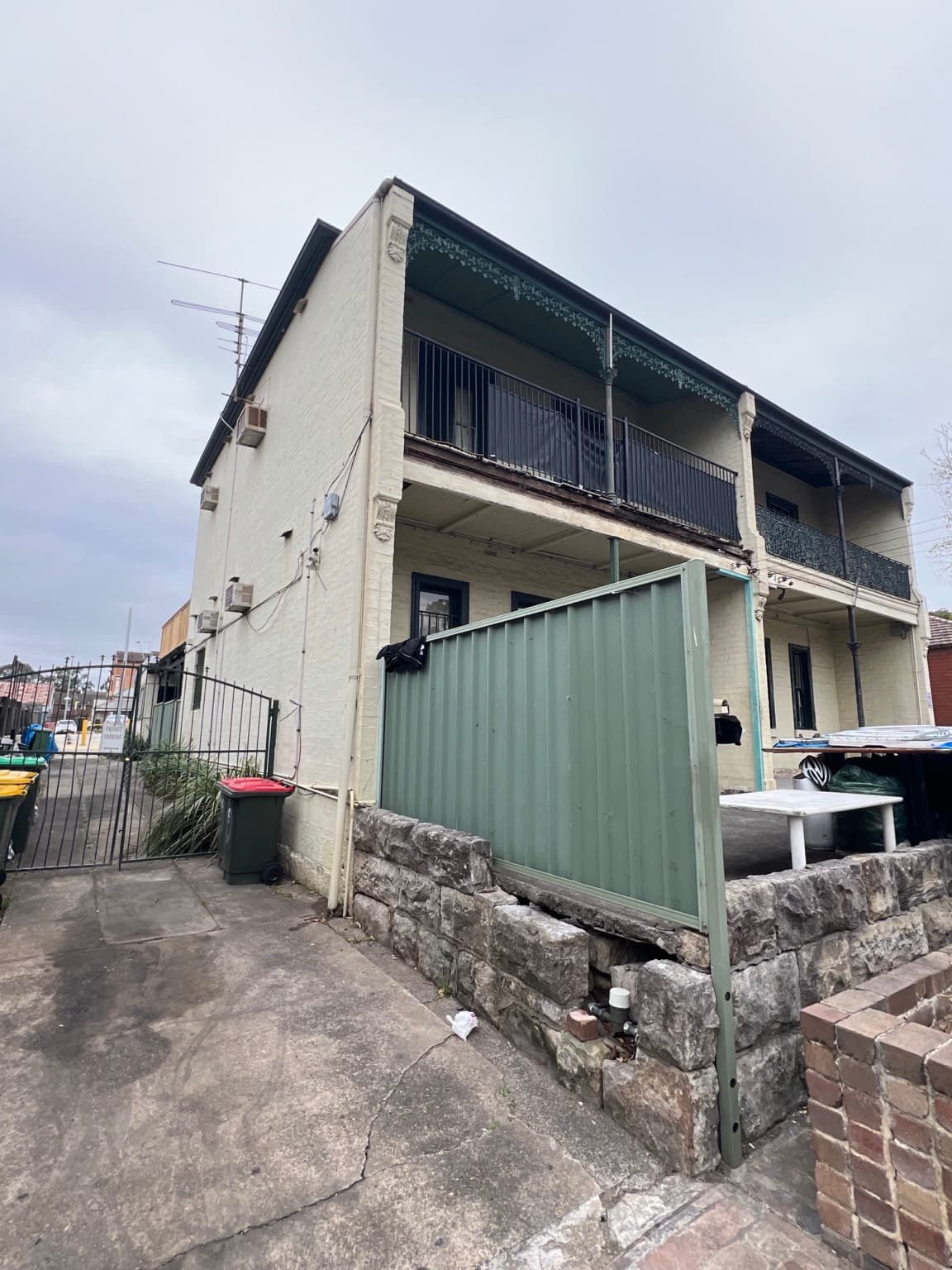 Granville property after exterior repainting in grey with Berger Solarscreen, viewed from the front corner, before