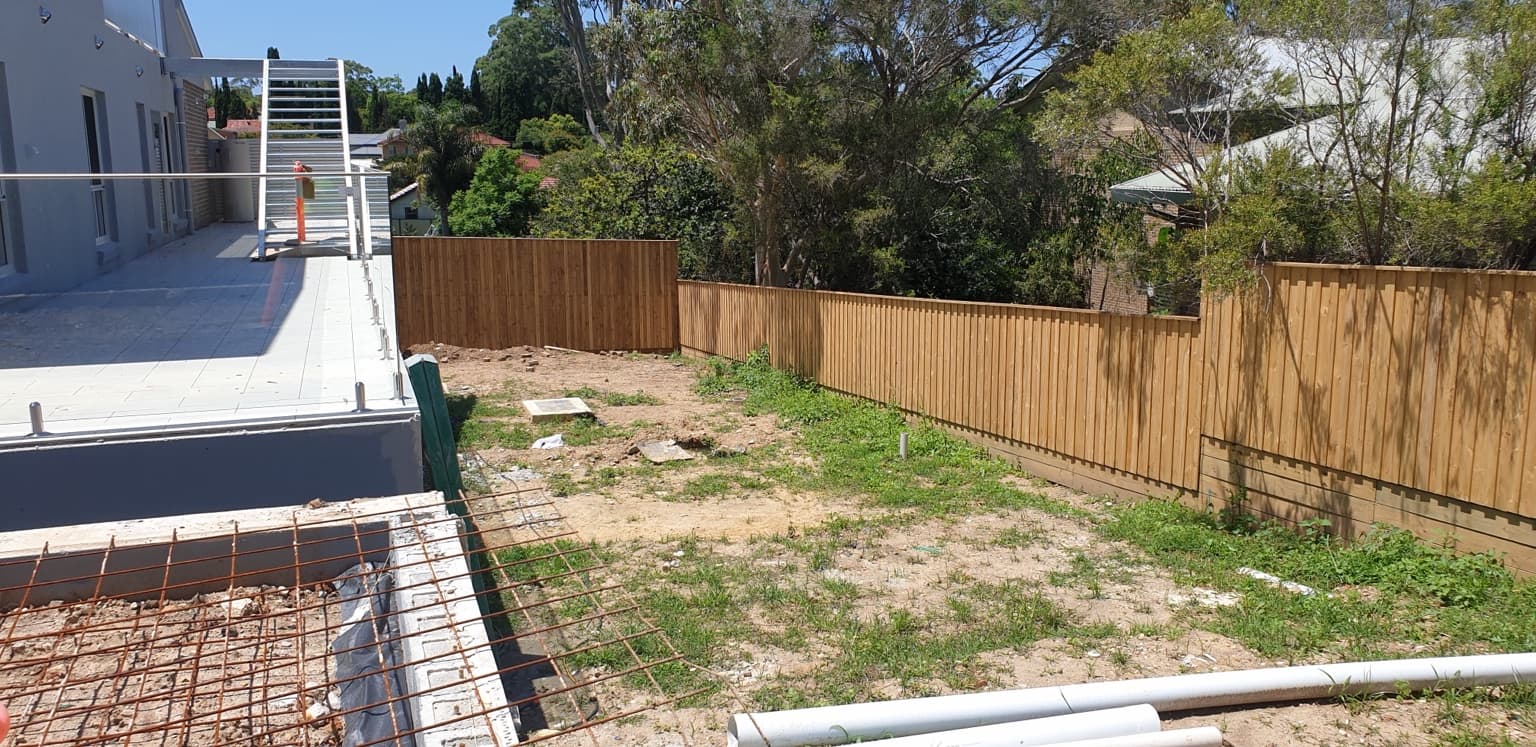 Dark painted timber boundary fence beside the building at Belonging Early Learning in Hornsby, before
