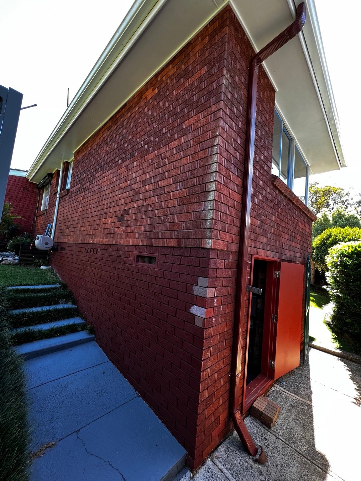 Painted side elevation and aluminium window frames in Cowan, before