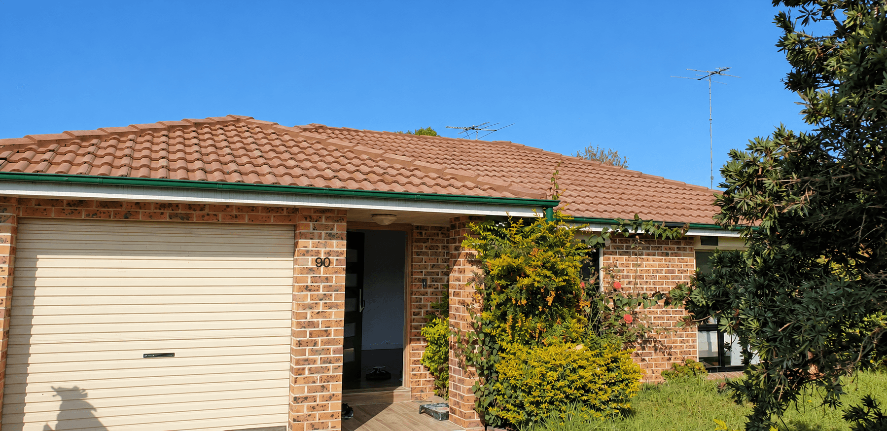Completed grey roof, pale painted brickwork and charcoal exterior details in St Clair, before