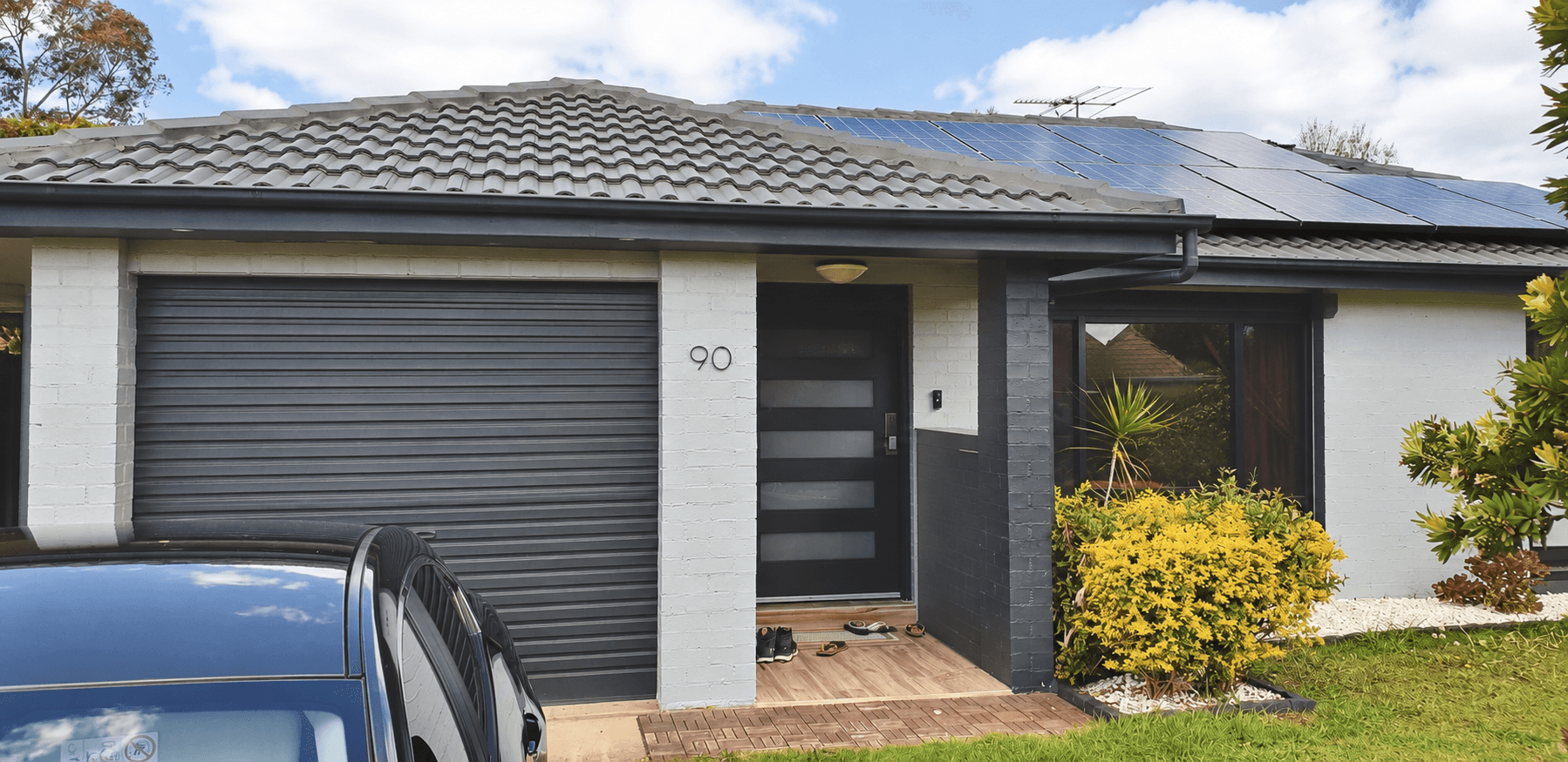 Completed grey roof, pale painted brickwork and charcoal exterior details in St Clair, after
